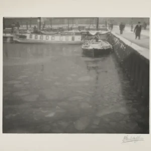 Photograph by Olaf Christoffersen of frozen vessels at Oslo Harbor during winter, with ice floes surrounding a barge and a larger boat in the background.