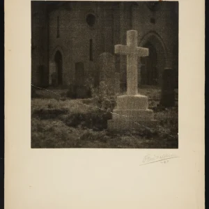Photograph by Olaf Christoffersen of a misty graveyard scene from 1927, with blurred crosses and church architecture evoking spirituality and the passage of time.