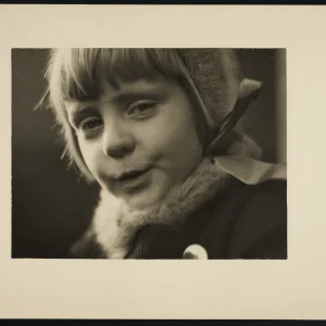 Portrait by Olaf Christoffersen of his daughter, Turid, from 1935, with soft light highlighting her youthful innocence and joyful expression.