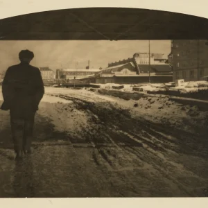 Photograph by Olaf Christoffersen from 1928 of a well-dressed gentleman walking through the now-extinct Vaterland district in Oslo, capturing a city in transition.