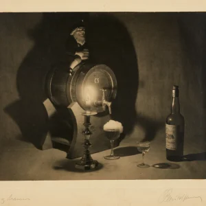 Photograph by Olaf Christoffersen of a still life featuring a beer barrel, aquavit bottle, and foaming glass of ale, evoking celebration and reflection.